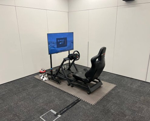 Side view of racing simulator setup at Asia Square Tower 1, Singapore – immersive driving experience for events and parties
