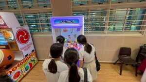 Toy Catcher claw machine game filled with plush toys at event in Bedok South Secondary School, Singapore