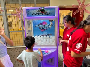 Classic claw machine game attraction at National Junior College, Singapore for corporate and birthday events