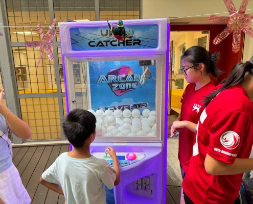 Classic claw machine game attraction at National Junior College, Singapore for corporate and birthday events