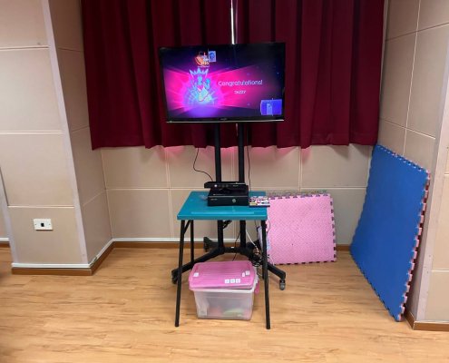 A Nintendo Wii setup featuring a TV screen, Wii console, and motion controllers placed on a table, prepared for interactive gameplay at Bedok South Secondary School, Singapore.
