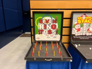 Kids playing ring toss carnival game at an indoor event in Singapore