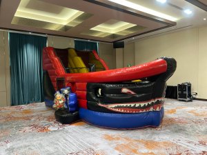 Kids jumping in indoor bouncy castle at rainy day event