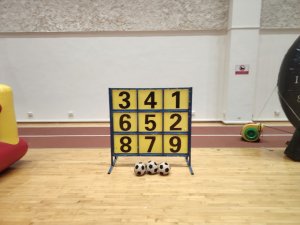 Players enjoying Lucky 9 carnival game at an indoor event setup