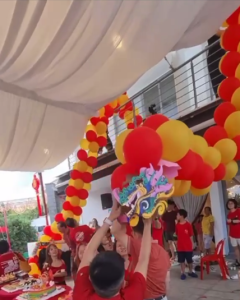 Balloon firecracker décor setup at a Chinese New Year 2026 event in Singapore, cost-effective festive decoration idea