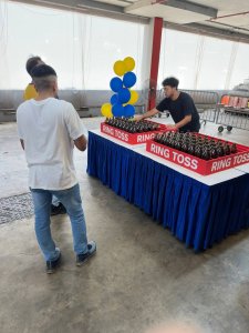 ring toss carnival game encouraging guest movement at community event in singapore